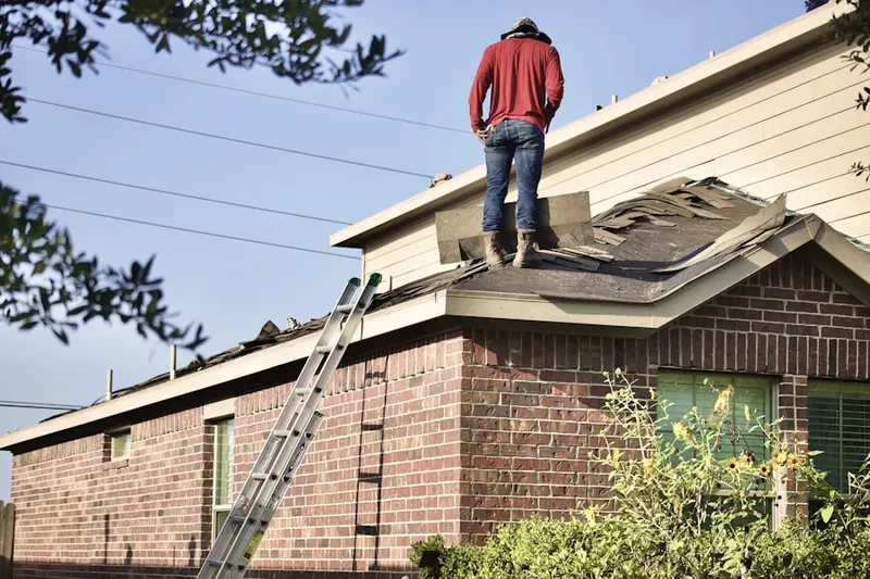Professional roofer working on a residential roof in Phelan